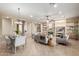 Well-lit living area featuring a stone fireplace, dining area, and open layout for entertaining at 22204 N 55Th St, Phoenix, AZ 85054