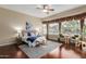 Comfortable main bedroom suite with natural light, sitting area, and wood flooring at 22204 N 55Th St, Phoenix, AZ 85054