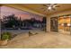 Covered patio with a ceiling fan offers views of the pool and desert landscaping at 22204 N 55Th St, Phoenix, AZ 85054