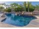 Backyard pool features serene rock waterfall and desert landscaping at 22204 N 55Th St, Phoenix, AZ 85054