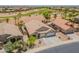 This is an aerial view of a beautiful home with a three car garage, desert landscaping, and a golf course nearby at 22625 N Van Loo Dr, Maricopa, AZ 85138