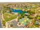 Community showcasing a park with a lake, golf course, basketball court, and well-maintained landscaping at 22625 N Van Loo Dr, Maricopa, AZ 85138