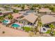 An aerial view of a home showcasing a private backyard oasis with a sparkling pool, patio, and lush landscaping at 22625 N Van Loo Dr, Maricopa, AZ 85138