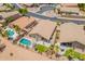 An aerial view of a home showcasing a private backyard oasis with a sparkling pool, patio, and lush landscaping at 22625 N Van Loo Dr, Maricopa, AZ 85138