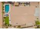 This is an aerial view of the roof of a home with a pool, patio, and other landscape features in the backyard at 22625 N Van Loo Dr, Maricopa, AZ 85138