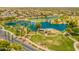 Community aerial showcasing lake, golf course, park with covered picnic area, and well maintained landscaping at 22625 N Van Loo Dr, Maricopa, AZ 85138
