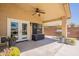 Spacious covered back patio with a ceiling fan, plenty of seating, and views of the backyard at 22625 N Van Loo Dr, Maricopa, AZ 85138