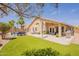 Expansive backyard showcases a refreshing pool, patio seating, artificial grass, and a covered patio for outdoor entertaining at 22625 N Van Loo Dr, Maricopa, AZ 85138