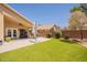 Spacious backyard patio featuring artificial turf, a covered area with fan, and lush landscaping at 22625 N Van Loo Dr, Maricopa, AZ 85138