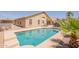 Inviting backyard pool with Baja step, ideal for cooling off on warm days with surrounding desert landscape at 22625 N Van Loo Dr, Maricopa, AZ 85138
