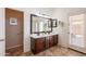 Primary bathroom with double sink vanity and door to the exterior at 22625 N Van Loo Dr, Maricopa, AZ 85138