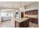 Open concept kitchen with island and view to living room at 22625 N Van Loo Dr, Maricopa, AZ 85138