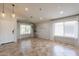 Airy living room with tile floors, large windows, and seamless access to the front entryway at 22625 N Van Loo Dr, Maricopa, AZ 85138