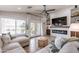 Comfortable living room with a fireplace, built-in shelving, and access to the outdoor patio at 22625 N Van Loo Dr, Maricopa, AZ 85138