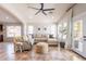 Cozy living room with tile floors, a comfortable sectional sofa, and bright natural light at 22625 N Van Loo Dr, Maricopa, AZ 85138