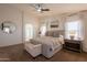 Bright main bedroom with a ceiling fan, ensuite, and comfortable, stylish decor at 22625 N Van Loo Dr, Maricopa, AZ 85138