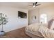 The main bedroom has neutral walls, carpet, and a ceiling fan at 22625 N Van Loo Dr, Maricopa, AZ 85138