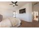 Spacious main bedroom with carpet, a ceiling fan, and a TV at 22625 N Van Loo Dr, Maricopa, AZ 85138