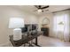 Home office with a modern desk setup, neutral walls, and a bright window at 22625 N Van Loo Dr, Maricopa, AZ 85138