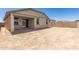 An expansive backyard with a covered patio offers space for outdoor activities at 22913 N 183Rd Dr, Surprise, AZ 85387