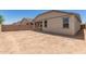 A spacious backyard features neutral stucco walls, trimmed windows and a brick fence surrounding the property at 22913 N 183Rd Dr, Surprise, AZ 85387