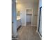 Bathroom featuring double sinks, stylish vanity, and a walk-in closet for plenty of storage at 22913 N 183Rd Dr, Surprise, AZ 85387