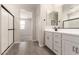 Bright bathroom showcasing double sink vanity, contemporary fixtures, and a glass-enclosed shower at 22913 N 183Rd Dr, Surprise, AZ 85387