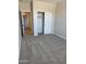 Another bright bedroom with neutral colors, carpet flooring, and a closet space at 22913 N 183Rd Dr, Surprise, AZ 85387