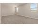 Bright bedroom with neutral carpet, two windows, and ample natural light at 22913 N 183Rd Dr, Surprise, AZ 85387