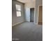 Bright bedroom with plush carpeting, a closet, and a window letting in natural light at 22913 N 183Rd Dr, Surprise, AZ 85387