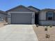 Charming single-story home featuring a spacious two-car garage and low-maintenance desert landscaping at 22913 N 183Rd Dr, Surprise, AZ 85387