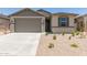 Charming single-story home featuring a two-car garage, neutral color palette, and desert landscaping at 22913 N 183Rd Dr, Surprise, AZ 85387