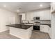 Bright kitchen featuring white cabinets, stainless appliances, and tile backsplash at 22913 N 183Rd Dr, Surprise, AZ 85387