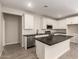 Bright kitchen featuring white cabinets, stainless appliances, and tile backsplash at 22913 N 183Rd Dr, Surprise, AZ 85387