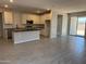Modern kitchen featuring white cabinets, stainless steel appliances, a center island, and tile floors at 22913 N 183Rd Dr, Surprise, AZ 85387