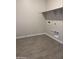 Functional laundry room with tiled flooring, connections for washer and dryer, and upper shelf at 22913 N 183Rd Dr, Surprise, AZ 85387