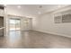 Spacious living room featuring neutral color palette, recessed lighting, and sliding glass door at 22913 N 183Rd Dr, Surprise, AZ 85387