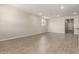 Spacious living room featuring neutral color palette, recessed lighting, and tile floors at 22913 N 183Rd Dr, Surprise, AZ 85387