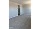 Spacious main bedroom with plush carpeting and access to the ensuite bathroom at 22913 N 183Rd Dr, Surprise, AZ 85387