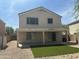 Spacious backyard with a covered patio, desert landscaping and easy-to-maintain synthetic grass at 23284 W Pima St, Buckeye, AZ 85326