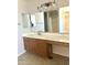 Bathroom vanity with a large counter area and well-lit mirrors at 23284 W Pima St, Buckeye, AZ 85326