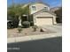 Inviting two-story home featuring a two-car garage and low-maintenance landscaping at 23284 W Pima St, Buckeye, AZ 85326