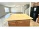 View of the kitchen island, refrigerator, and open access to the living room at 23284 W Pima St, Buckeye, AZ 85326