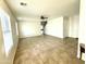 Bright, spacious living room features neutral paint, tile flooring, and a ceiling fan at 23284 W Pima St, Buckeye, AZ 85326