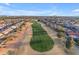 An aerial view showcases the community's golf course surrounded by homes at 23753 S Vacation Way, Sun Lakes, AZ 85248