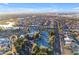 Aerial view shows the neighborhood's tennis courts with manicured landscaping and pool at 23753 S Vacation Way, Sun Lakes, AZ 85248