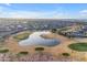 An aerial view showcases the community's lush golf course with a large pond at 23753 S Vacation Way, Sun Lakes, AZ 85248