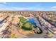 A lush golf course is seen in this aerial view of the community, with pond and landscaping at 23753 S Vacation Way, Sun Lakes, AZ 85248