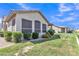 Back exterior view of a well-maintained home featuring a lawn and lush landscaping at 23753 S Vacation Way, Sun Lakes, AZ 85248