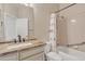 Bathroom featuring shower over tub, single sink with granite counters, and tile floors at 23753 S Vacation Way, Sun Lakes, AZ 85248